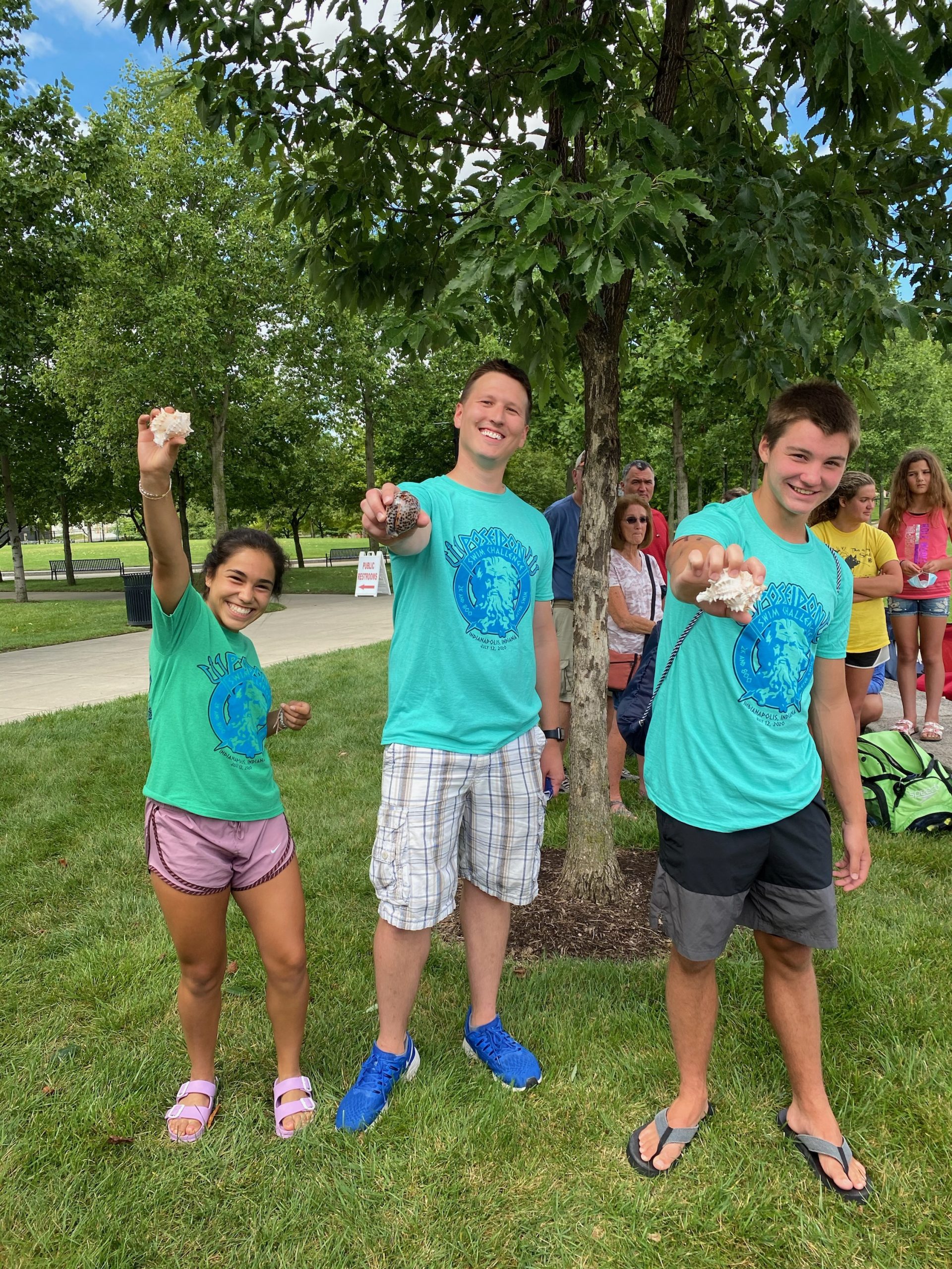 Maria, Coach and Sean showing off their hardware following the Poseidon Challenge.